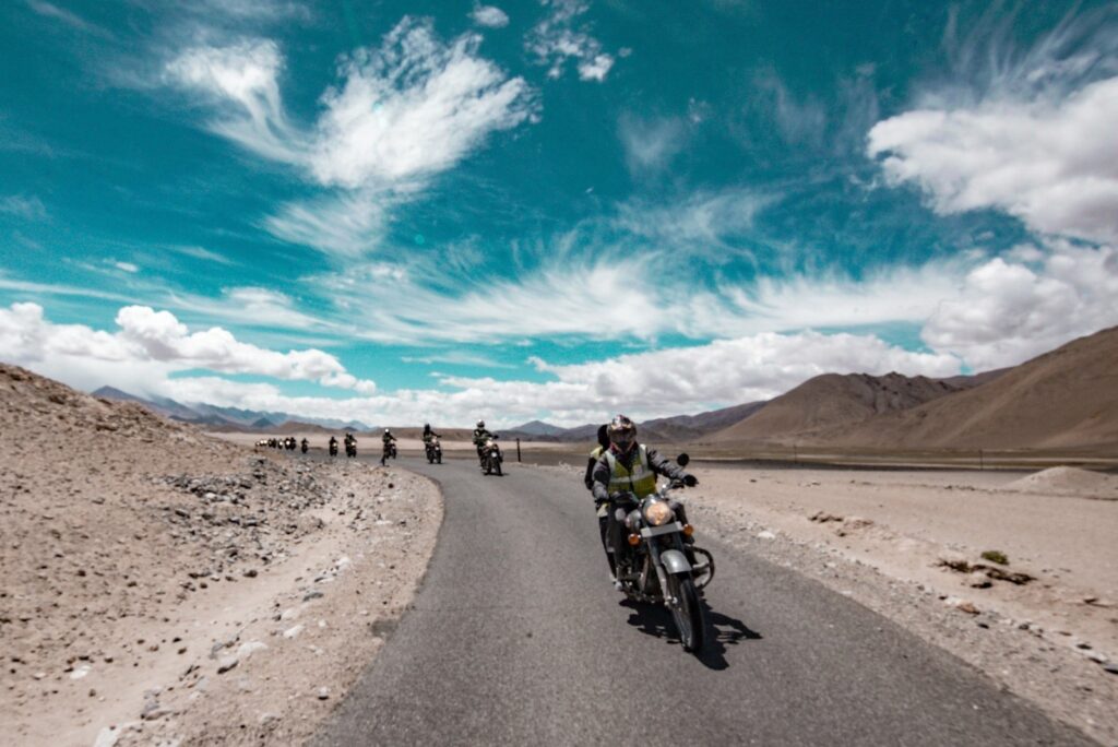 Bikers motorbiking down a road in India