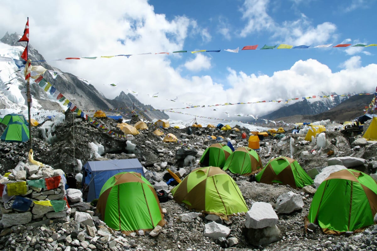 Colorful tents and Tibetan prayer flags at Everest Base Camp, Khumbu Region, Nepal. Photo by rmnunes via DepositPhotos