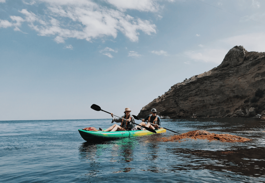 A sporty couple going into kayak water sport