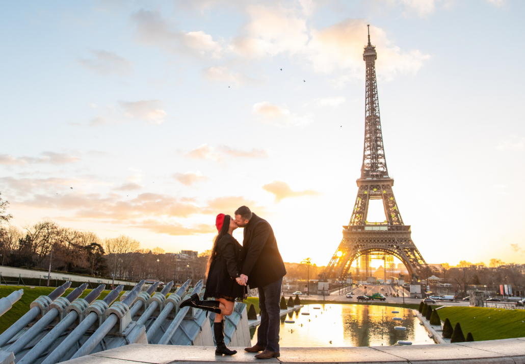 Shot of the happy couple taking pictures with Eiffel Tower on the background, Paris, France