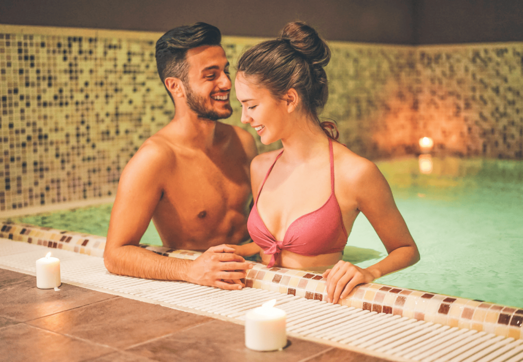 Happy couple relaxing in an ancient bath 