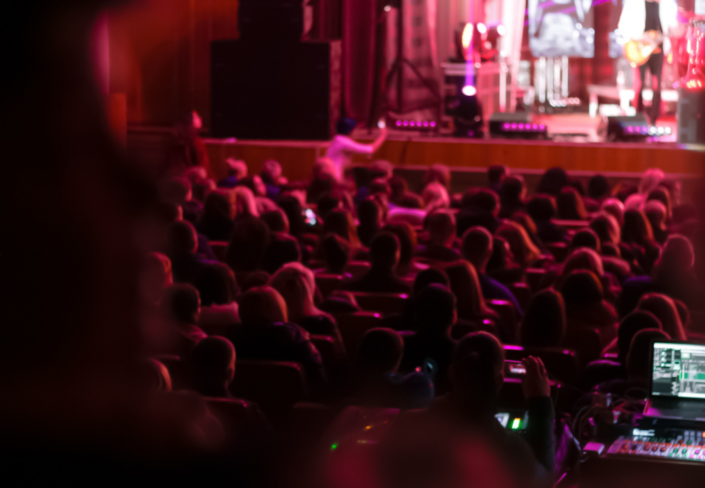 The audience sits in the hall, engrossed in the comedy festival
