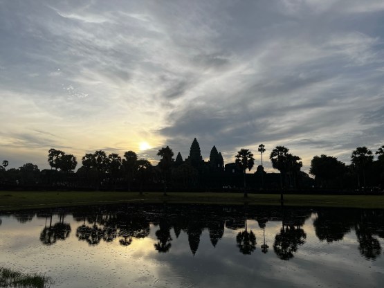 angkor wat reflecting on the pond at sunrise