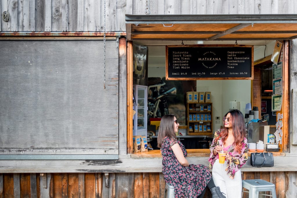 people eating at market stall in matakana near leigh