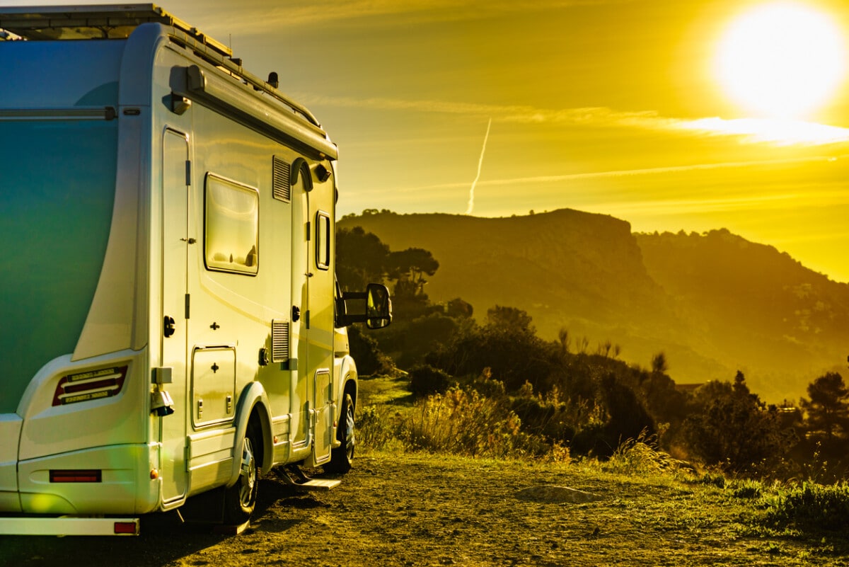 Camper recreational vehicle camping on nature in mountains, Andalucia Spain. Morning light. Vacation, travel in motor home.