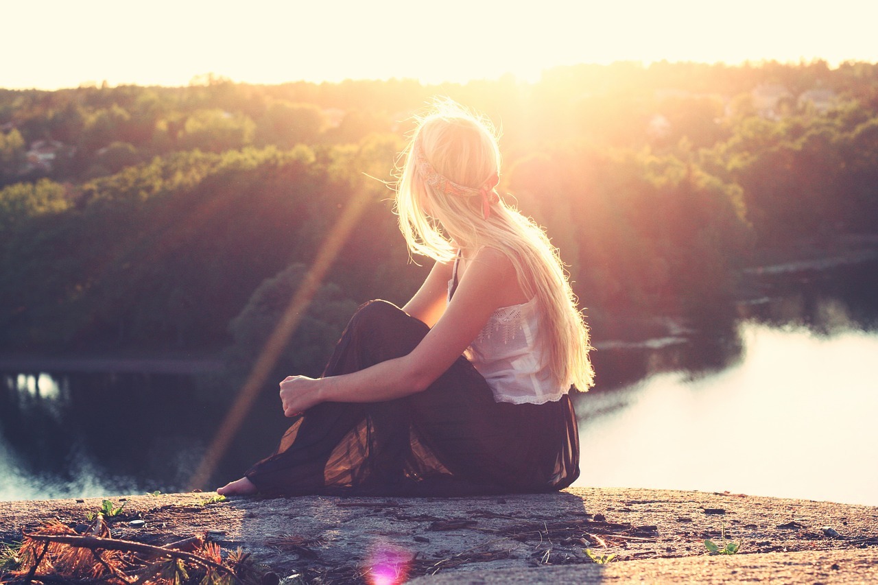 a girl sitting in sun light